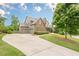 A beautiful property with a curved driveway and lush landscaping offers curb appeal at , Cumming, GA 30041