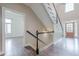 Elegant foyer with hardwood floors, staircase with black handrail, and a view of the front door at , Cumming, GA 30041
