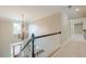 Upstairs hallway view with elegant chandelier and view of front door and hardwood flooring at , Cumming, GA 30041