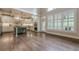 Gourmet kitchen featuring custom cabinetry, a large island, hardwood floors, and stainless steel appliances at , Cumming, GA 30041