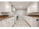 Functional laundry room with abundant cabinets, granite countertops, and modern washer and dryer at , Cumming, GA 30041