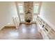 Bright living room with hardwood floors, stone fireplace, built-in shelving, and soaring windows at , Cumming, GA 30041