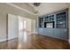 Spacious living room with hardwood floors and custom built-in shelving and open doorway at , Cumming, GA 30041