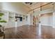 Open-concept living room with built-in shelves, hardwood floors, and staircase leading to the second floor at , Cumming, GA 30041