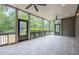 Relaxing screened-in porch with tile flooring, ceiling fans, and views of the private backyard at , Cumming, GA 30041