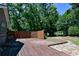 A spacious wooden deck surrounded by lush greenery and a privacy fence offers great outdoor living at 35 Brooke Holw, Covington, GA 30016