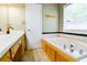 Bathroom with vanity, jetted tub, and natural light at 35 Brooke Holw, Covington, GA 30016