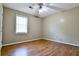 Bedroom features hardwood floors, a ceiling fan, and natural light from a window at 35 Brooke Holw, Covington, GA 30016