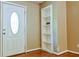 This foyer has hardwood floors, a front door with a glass window, and a built-in bookshelf at 35 Brooke Holw, Covington, GA 30016