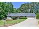 Classic home boasts a well-manicured lawn, an American flag, and an ample driveway at 35 Brooke Holw, Covington, GA 30016