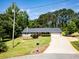 Inviting home features a well-kept lawn, mature trees, and an ample driveway at 35 Brooke Holw, Covington, GA 30016