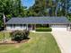 Charming single-story home boasts a well-manicured lawn and a classic red front door at 35 Brooke Holw, Covington, GA 30016
