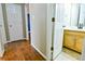 Hallway with wood floors leads to bathroom at 35 Brooke Holw, Covington, GA 30016