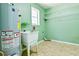 Utility room with a water heater, sink, shelving, and green walls at 35 Brooke Holw, Covington, GA 30016