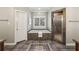 Well-appointed bathroom featuring a tiled tub, glass-enclosed shower, and stylish neutral finishes at 905 Brooksglen Dr, Roswell, GA 30075