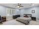 Comfortable bedroom featuring a ceiling fan, shuttered windows, and a calming blue color scheme at 905 Brooksglen Dr, Roswell, GA 30075