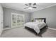 This primary bedroom has a ceiling fan, light gray paint and large windows with shutters at 905 Brooksglen Dr, Roswell, GA 30075