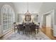 Formal dining room with high ceilings, chandelier lighting, and large arched window at 905 Brooksglen Dr, Roswell, GA 30075