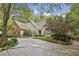 Well-maintained home featuring a circular driveway and professionally landscaped front yard with mature trees at 905 Brooksglen Dr, Roswell, GA 30075