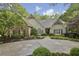 Charming home with a stone facade, manicured landscaping, and a welcoming front entrance at 905 Brooksglen Dr, Roswell, GA 30075
