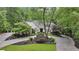 Inviting traditional home featuring stone accents, mature landscaping, and a circular driveway at 905 Brooksglen Dr, Roswell, GA 30075