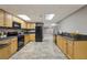 Basement kitchen features black appliances, light wood cabinets, and tile floors at 905 Brooksglen Dr, Roswell, GA 30075