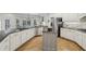 Open concept kitchen with stainless steel appliances, central island, and breakfast bar seating at 905 Brooksglen Dr, Roswell, GA 30075