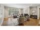 Cozy living room features a fireplace, large windows, and hardwood floors with area rug at 905 Brooksglen Dr, Roswell, GA 30075