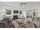 Bright living room featuring hardwood floors, fireplace, large windows, and sliding glass doors at 905 Brooksglen Dr, Roswell, GA 30075