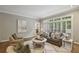 Bright living room with large windows, hardwood floors, and a cozy seating area at 905 Brooksglen Dr, Roswell, GA 30075
