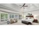Bright main bedroom with a tray ceiling, large windows, and comfortable sitting area at 905 Brooksglen Dr, Roswell, GA 30075