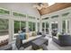 Bright sunroom with vaulted ceilings and numerous windows overlooking lush greenery at 905 Brooksglen Dr, Roswell, GA 30075