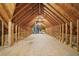 Unfinished attic featuring wood beams and plywood flooring at 973 Peachtree Battle Ave, Atlanta, GA 30327