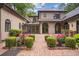 Beautiful backyard with manicured landscaping, flowers, and brick patio at 973 Peachtree Battle Ave, Atlanta, GA 30327
