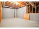 Unfinished basement with concrete floor, wood framing, and exposed ceiling at 973 Peachtree Battle Ave, Atlanta, GA 30327