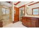 Elegant bathroom features a glass-enclosed shower, custom vanity, and refined wood accents for a luxurious feel at 973 Peachtree Battle Ave, Atlanta, GA 30327