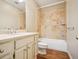 Well-lit bathroom features a combination shower-tub, single sink vanity, and updated fixtures at 973 Peachtree Battle Ave, Atlanta, GA 30327
