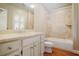Well-lit bathroom with a shower-tub combo and vanity at 973 Peachtree Battle Ave, Atlanta, GA 30327