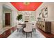 Elegant dining room with a striking red ceiling, chandelier, and seating for eight guests at 973 Peachtree Battle Ave, Atlanta, GA 30327
