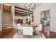 Open concept dining area leads to a kitchen and living room with hardwood floors and stairway at 973 Peachtree Battle Ave, Atlanta, GA 30327