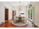 Cozy dining room with a round table, hardwood floors, and elegant lighting fixture at 973 Peachtree Battle Ave, Atlanta, GA 30327