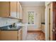 Bright laundry room with tile flooring, cabinetry, counter space and washer and dryer at 973 Peachtree Battle Ave, Atlanta, GA 30327