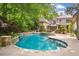 Inviting backyard pool with stone accents surrounded by lush landscaping and mature trees at 973 Peachtree Battle Ave, Atlanta, GA 30327