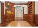 Beautiful study with custom wood paneling and built-in bookshelves leads to a staircase at 973 Peachtree Battle Ave, Atlanta, GA 30327