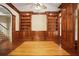 Elegant study boasts custom wood paneling, built-in bookshelves and hardwood floors at 973 Peachtree Battle Ave, Atlanta, GA 30327