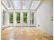 Bright sunroom with glass ceiling and views of the landscaped yard providing a relaxing natural light-filled space at 973 Peachtree Battle Ave, Atlanta, GA 30327