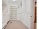 This walk-in closet is well-appointed with custom storage, providing organized space for clothing and accessories at 973 Peachtree Battle Ave, Atlanta, GA 30327
