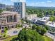 Elevated view of the building complex surrounded by lush greenery and a distant skyline at 1421 Peachtree Ne St # 304, Atlanta, GA 30309