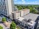Elevated view of condos and city, showcasing greenery, parking, and cityscape in the distance at 1421 Peachtree Ne St # 304, Atlanta, GA 30309