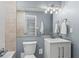 Well-lit bathroom featuring a vanity with ample counter space, a toilet, and a decorative mirror at 1421 Peachtree Ne St # 304, Atlanta, GA 30309